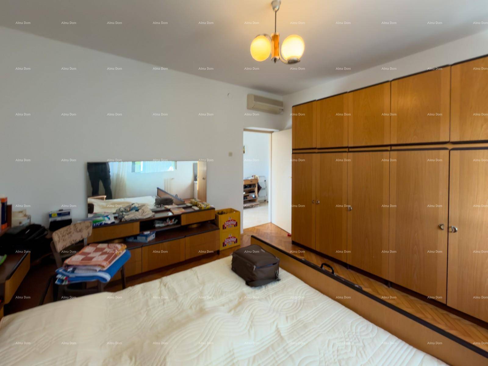 Schlafzimmer mit großem Einbauschrank und offenem Zugang zu einem weiteren Raum.