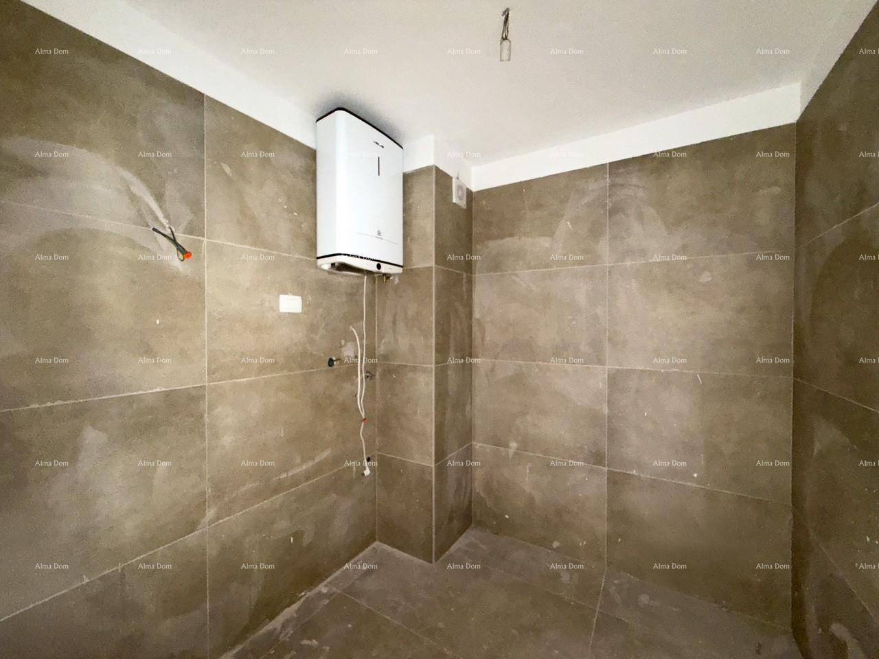 Funktionaler Hauswirtschaftsraum mit Fliesenwänden und installiertem Warmwasserbereiter.