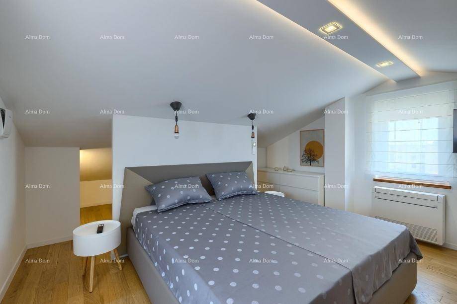 Dachgeschoss-Schlafzimmer mit Doppelbett, Holzboden und schrägen Wänden, modern eingerichtet.