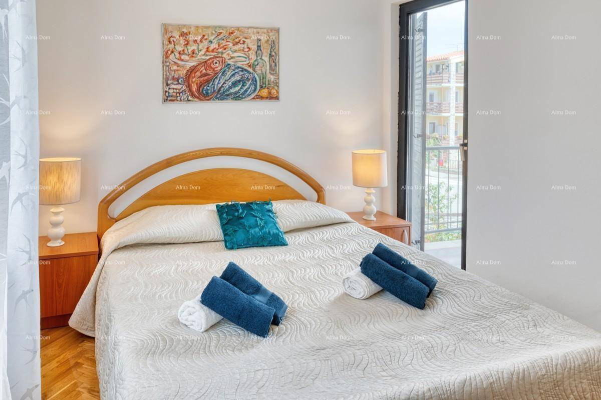 Helles Schlafzimmer mit Holzbett, Parkettboden und direktem Zugang zu einem Außenbereich.