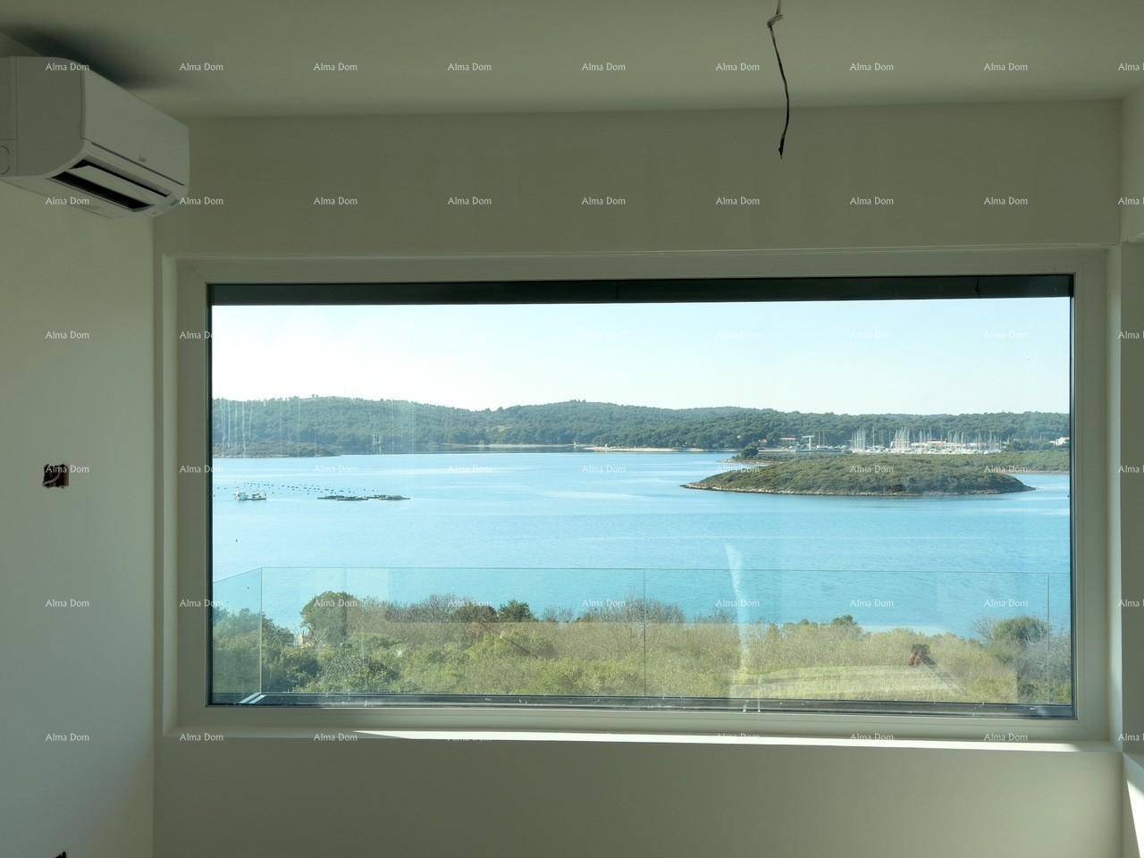 Großes Panoramafenster bietet einen weiten Blick auf die Bucht und die bewaldete Küste.