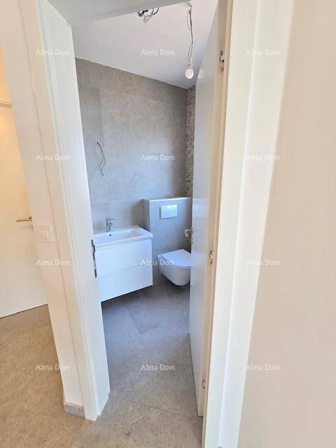 Modernes Badezimmer mit Wand-WC, Waschtisch und stilvollen Fliesen an den Wänden.