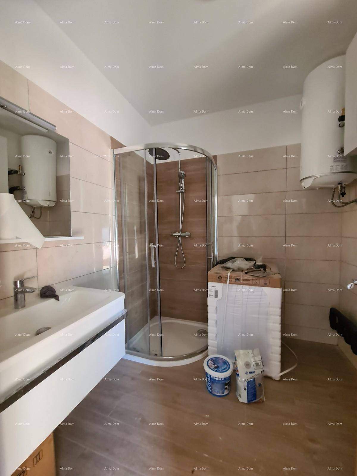 Modernes Badezimmer mit Duschkabine, Waschbecken und Wandfliesen in Erdtönen.