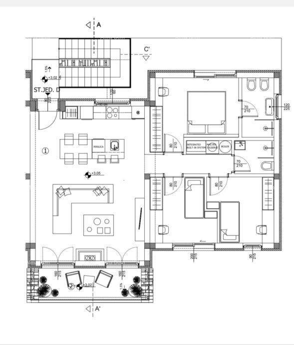 Detaillierter Grundriss mit offenem Wohnbereich, Küche und Schlafzimmern.