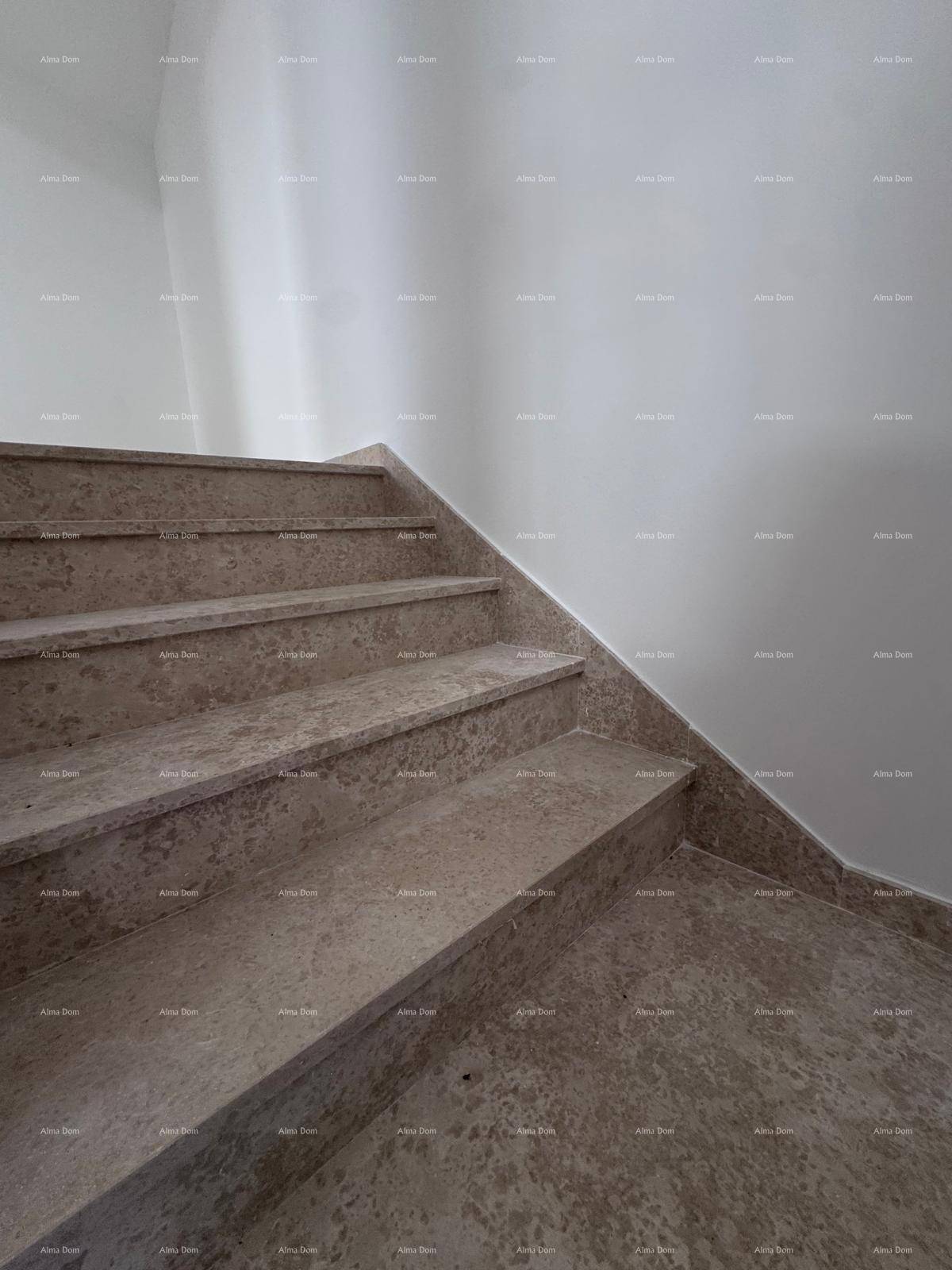 Nahaufnahme einer eleganten Treppe mit hellbraunen Steinstufen, die zu den oberen Etagen führt.