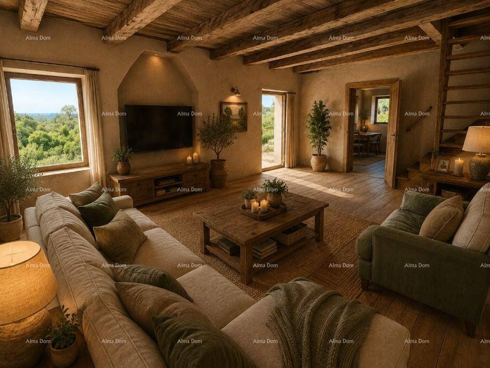 Gemütliches Wohnzimmer mit Holzbalkendecke, bequemen Sofas und Blick ins Grüne.