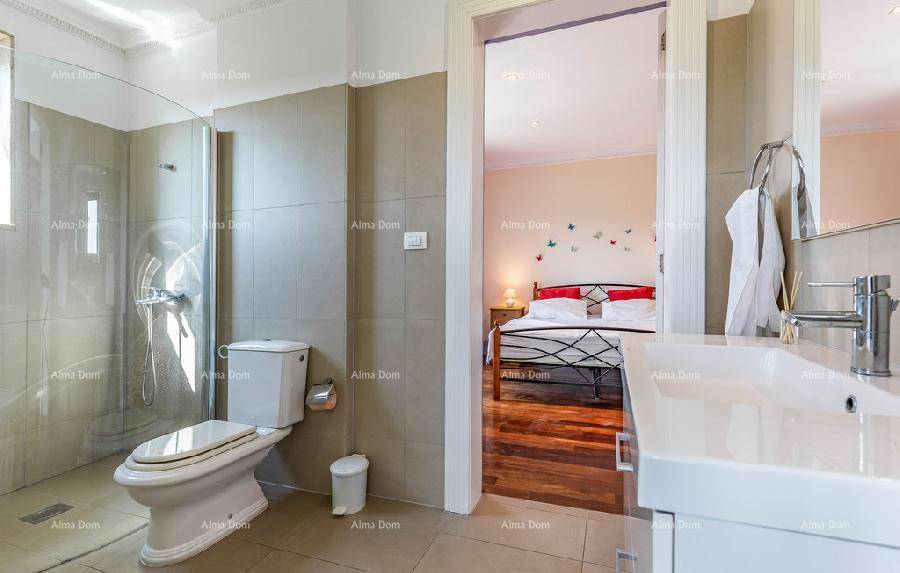 Funktionales Badezimmer mit Toilette, Duschbereich und direktem Zugang zu einem Schlafzimmer.