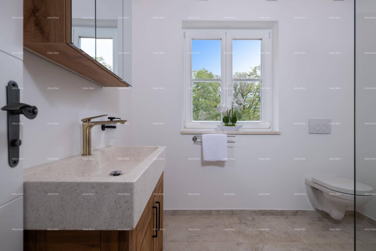 Helles Badezimmer mit modernem Waschtisch, Wand-WC und Fenster mit Blick ins Grüne.