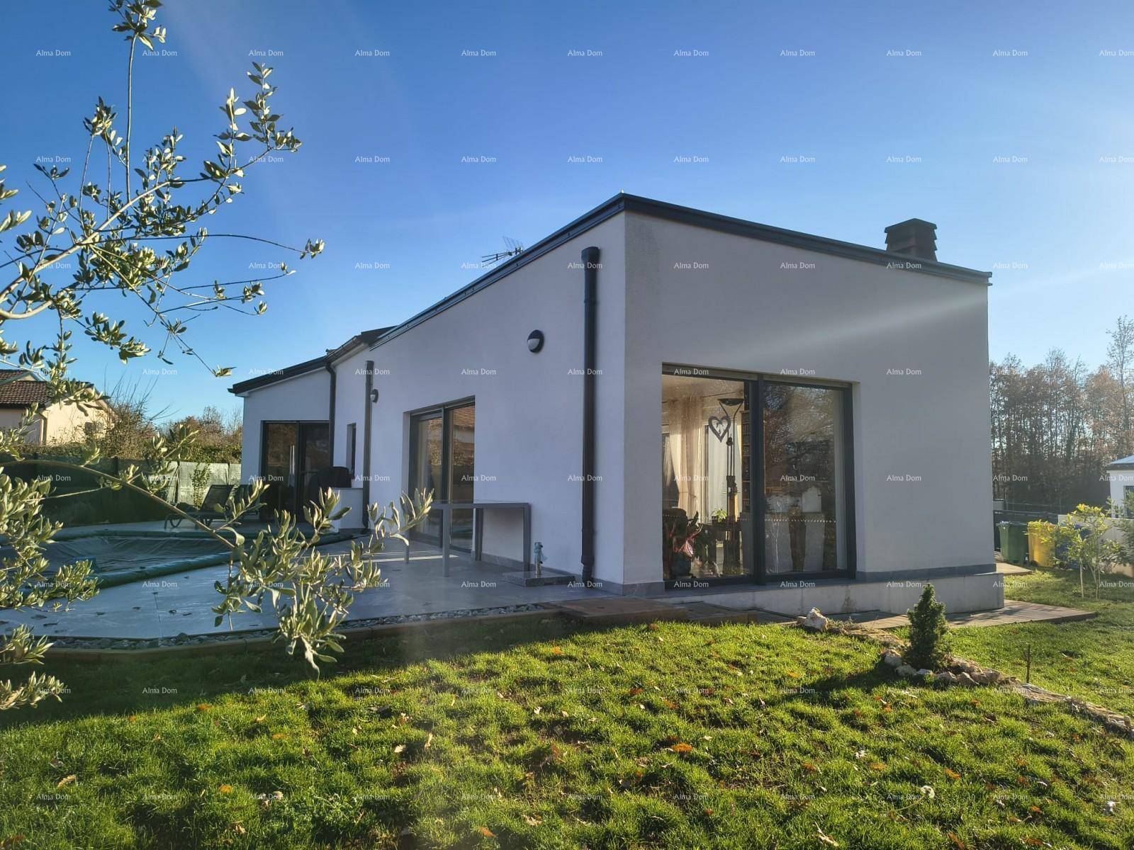 Modernes Einfamilienhaus mit weißer Fassade und großzügiger Rasenfläche.