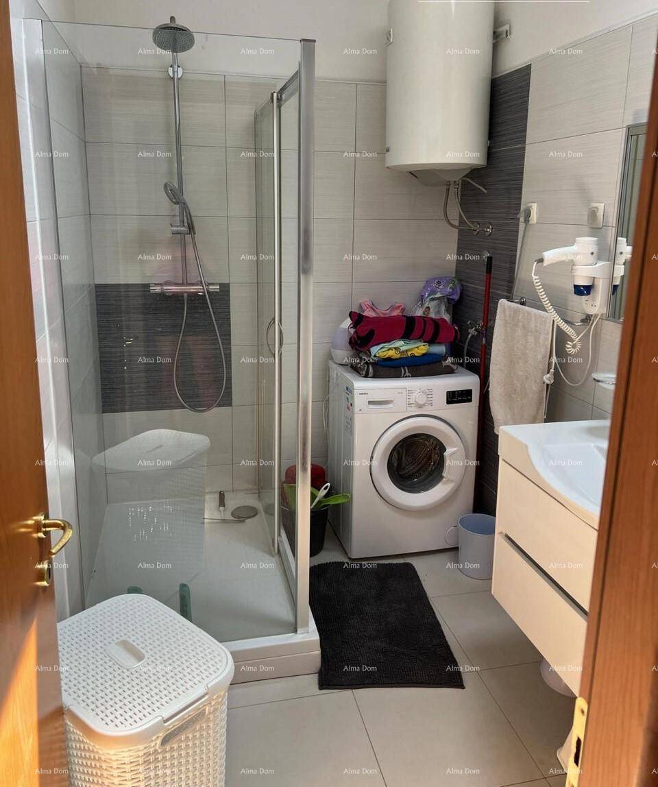 Modernes Badezimmer mit Duschkabine, Waschmaschine und einem schwebenden Waschtischunterschrank.