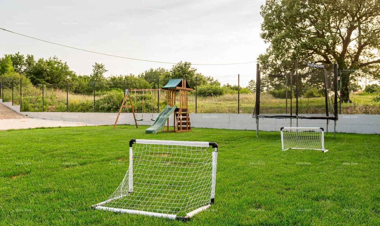 Großer Gartenbereich mit Kinderspielplatz, Rutsche, Schaukeln, Trampolin und Fußballtoren.