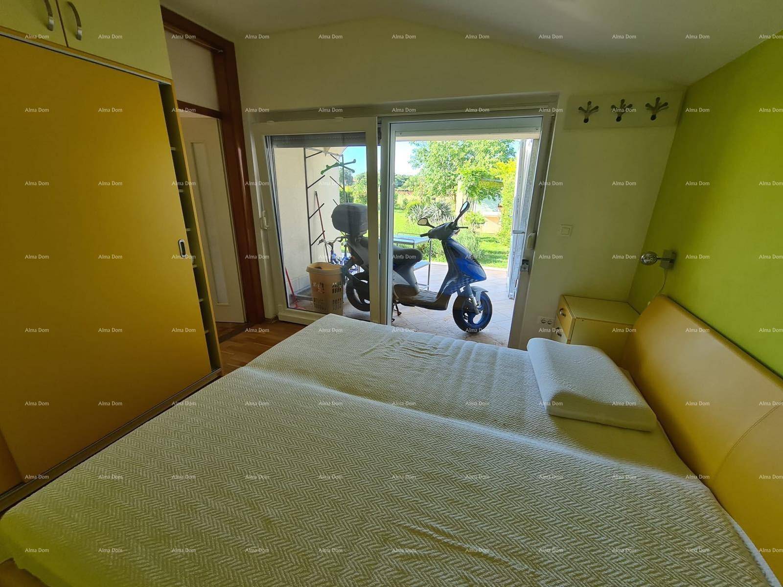 Schlafzimmer mit großen Schiebetüren, die zu einem Außenbereich mit Blick ins Grüne führen.