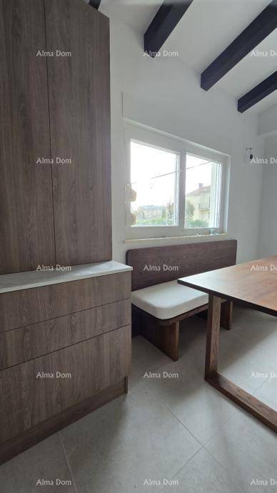 Essbereich in der Küche mit Holztisch, Sitzbank und Blick nach draußen durch das Fenster.
