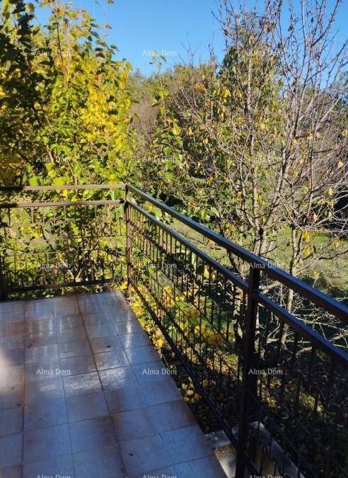 Balkon mit Fliesenboden und Metallgeländer, bietet einen schönen Blick ins Grüne.
