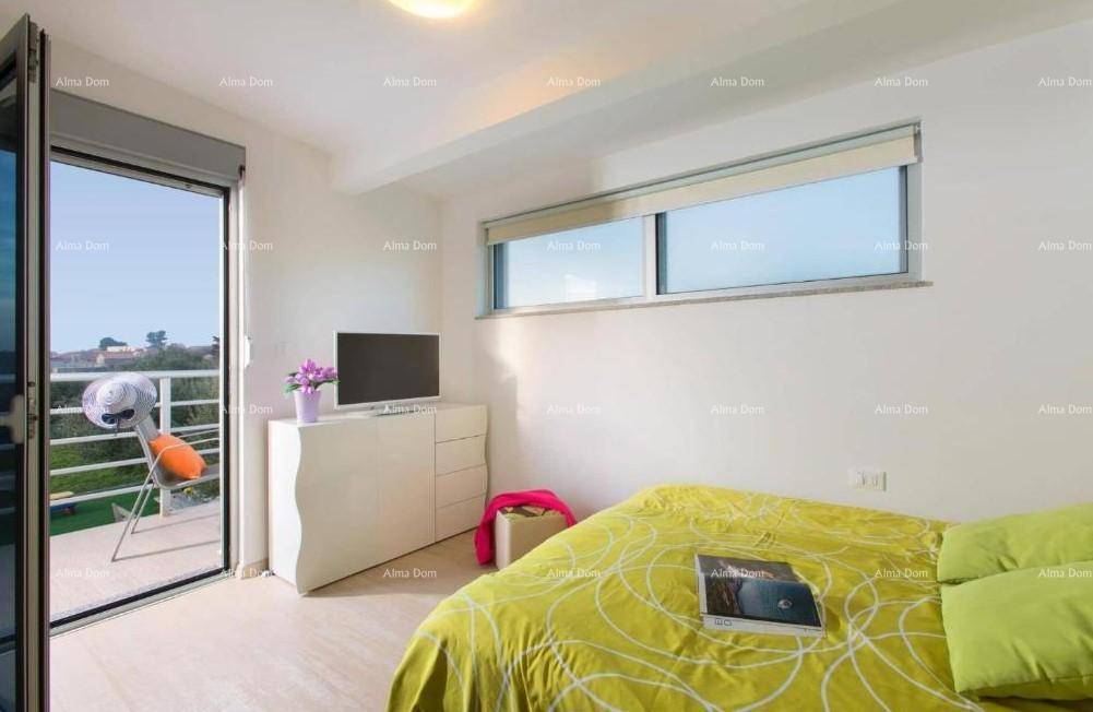 Modernes Schlafzimmer mit Doppelbett, Kommode und großem Fenster mit Zugang zum Balkon.