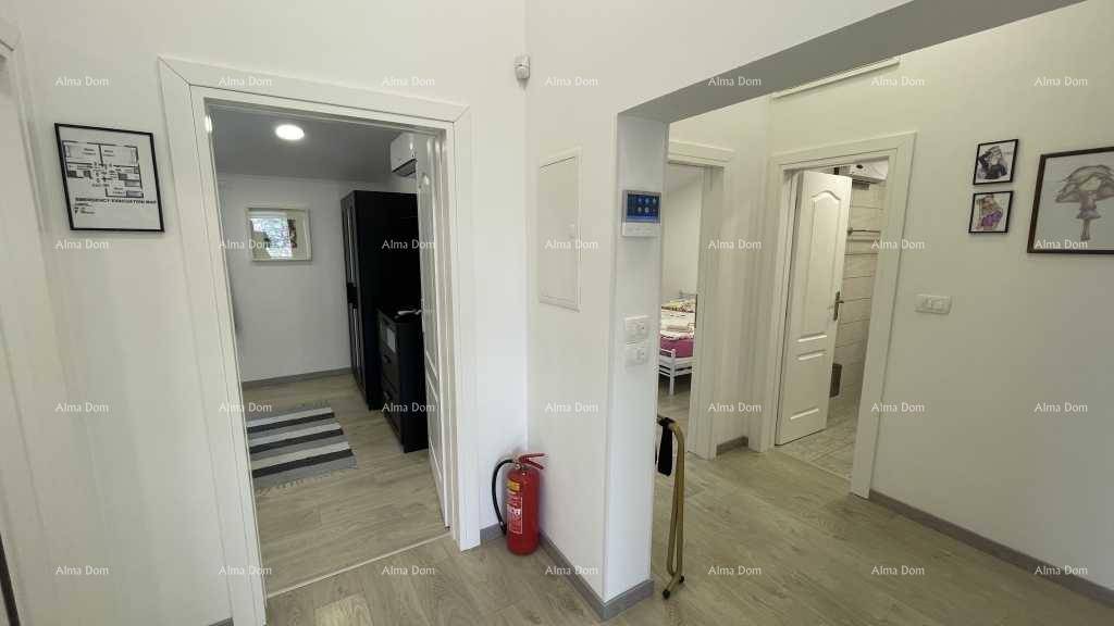 Heller Flur mit Feuerlöscher und Zugang zu verschiedenen Wohnbereichen des Hauses.