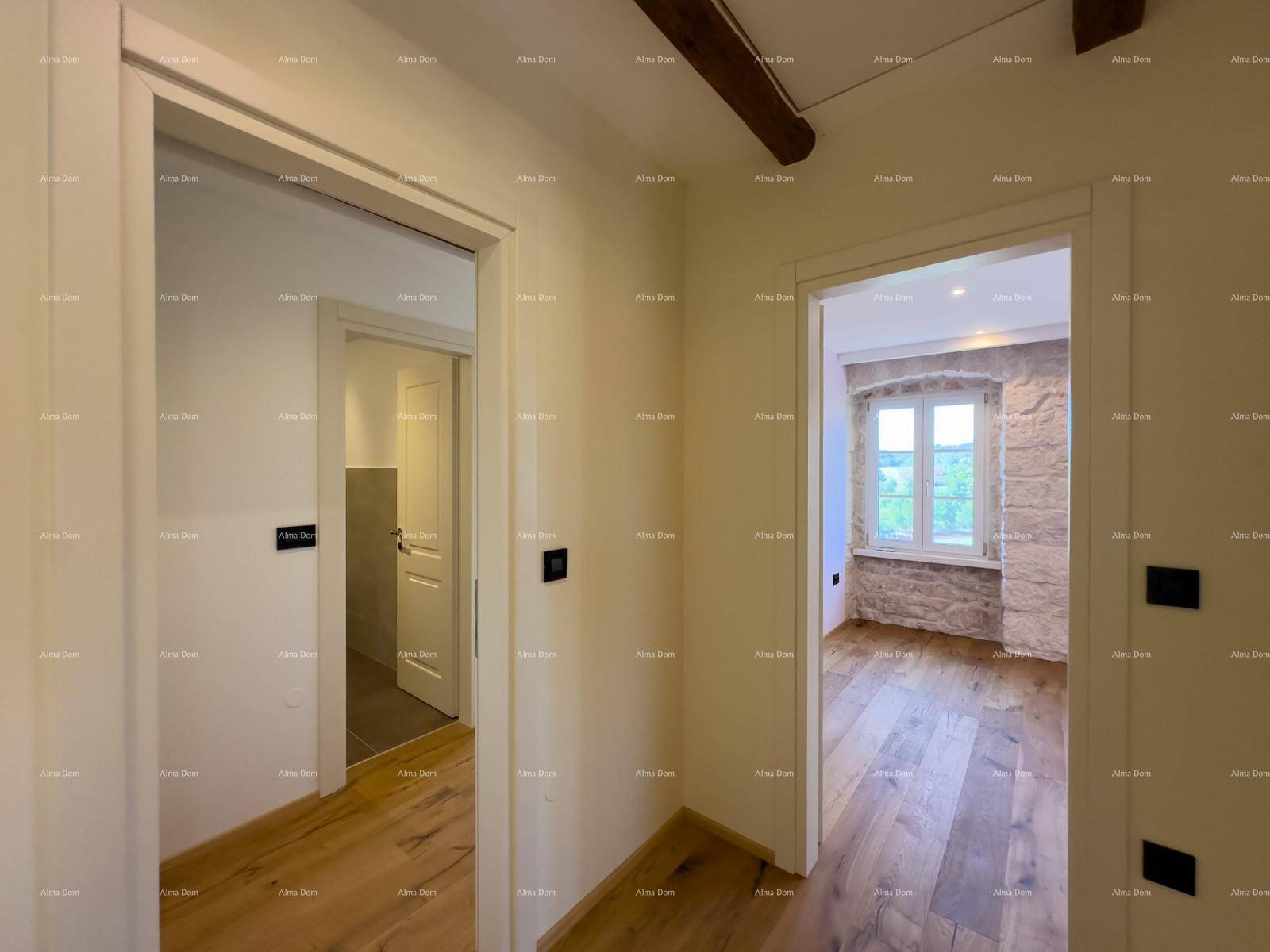 Flur mit zwei Türen, die zu einem Badezimmer und einem Zimmer mit Steinwand führen.