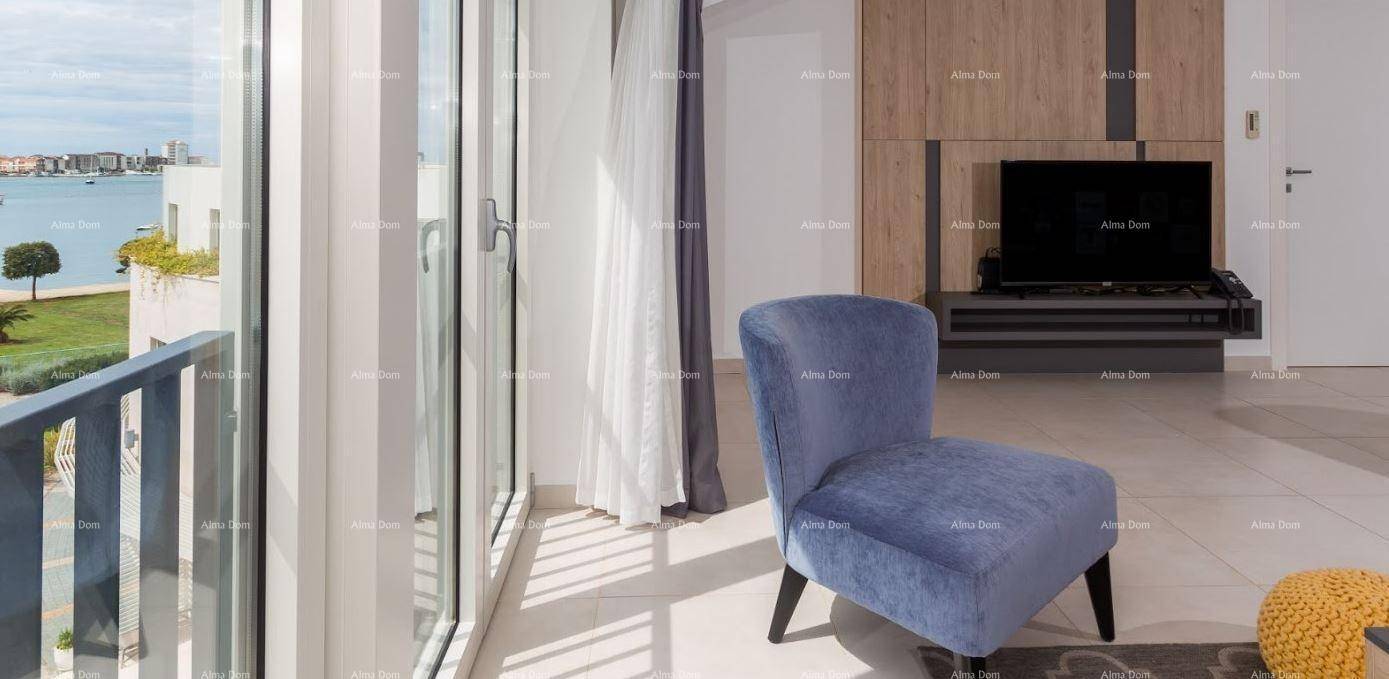 Gemütlicher Sessel am Fenster mit weitem Blick auf das Meer und die umliegende Bebauung.