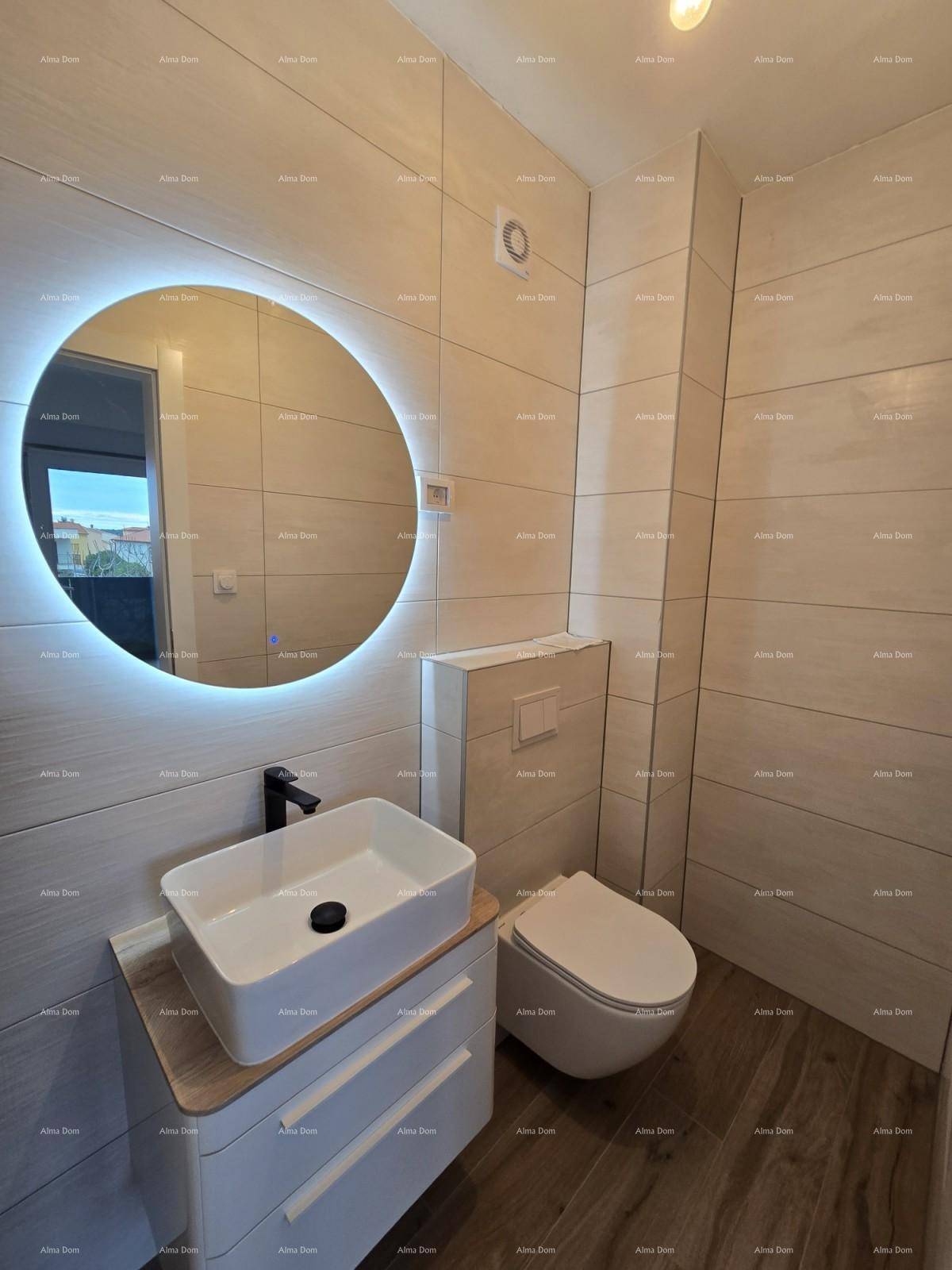Modernes Gäste-WC mit Hänge-WC, Aufsatzwaschbecken und beleuchtetem Spiegel.
