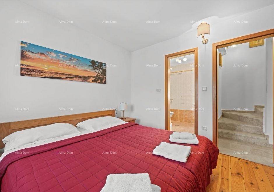 Gemütliches Schlafzimmer mit Doppelbett, Holzboden und direktem Zugang zum Badezimmer.