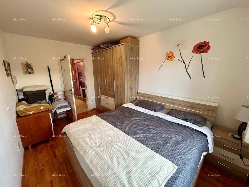 Gemütliches Schlafzimmer mit Doppelbett, Holzschrank und Holzboden.