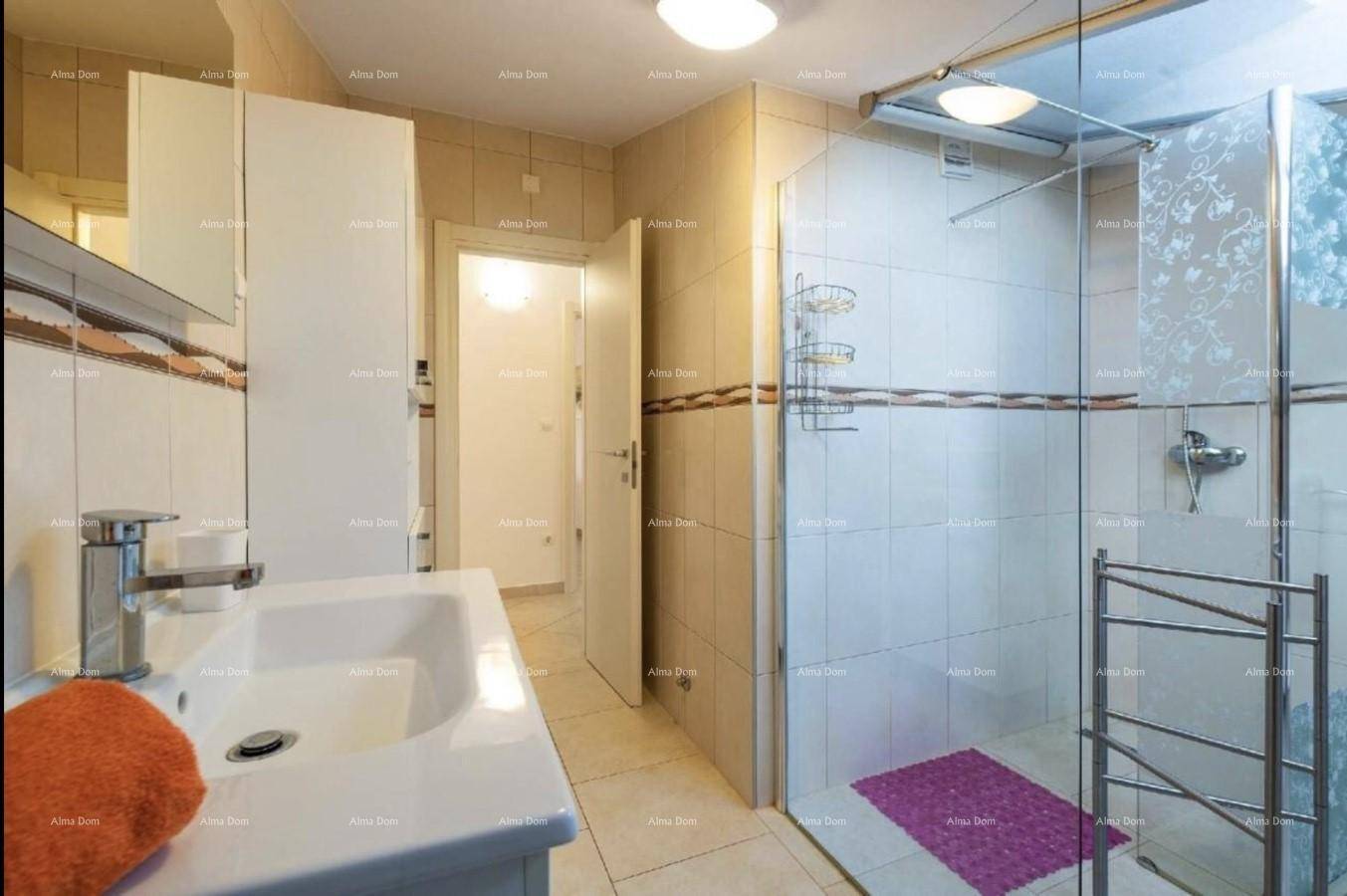Helles Badezimmer mit Waschbecken, Spiegelschrank und Duschkabine.