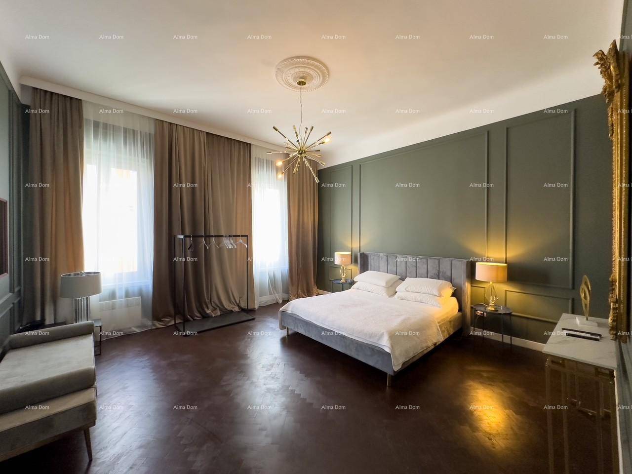 Elegantes Schlafzimmer mit dunklem Holzboden, grünen Wandpaneelen und einem auffälligen Kronleuchter.