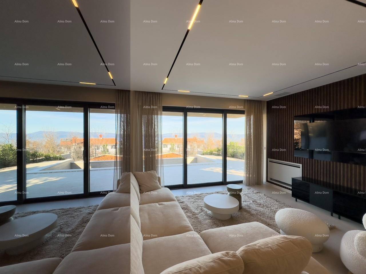 Helles Wohnzimmer mit modernen Möbeln, großen Fenstern und Panoramablick auf die Landschaft.