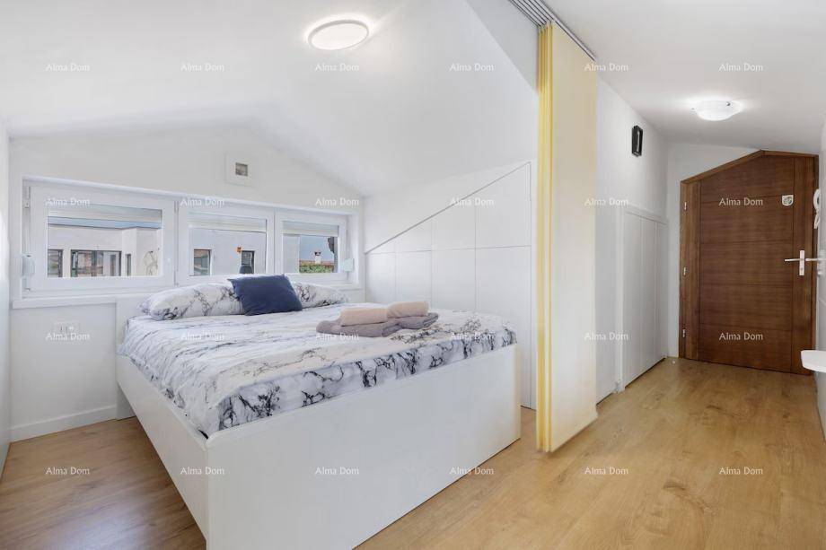 Heller Schlafbereich mit modernem Bett, Fensterfront und Holztür, unter einem Schrägdach gelegen.