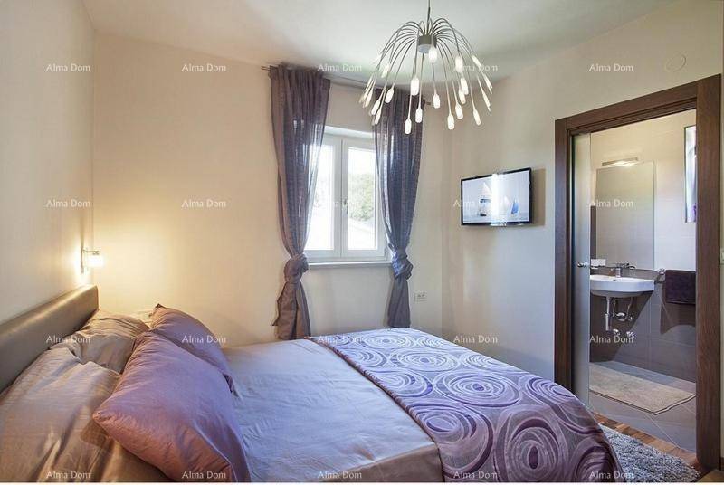 Gemütliches Schlafzimmer mit lila Bettwäsche und direktem Zugang zu einem modernen Badezimmer.