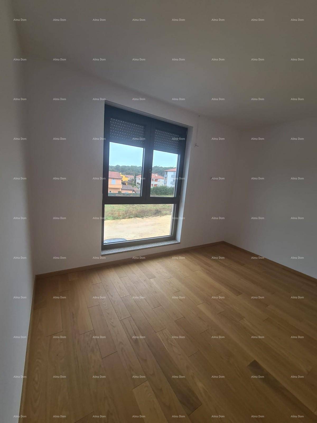 Helles Schlafzimmer mit Parkettboden und großem Fenster, das einen Blick ins Grüne bietet.