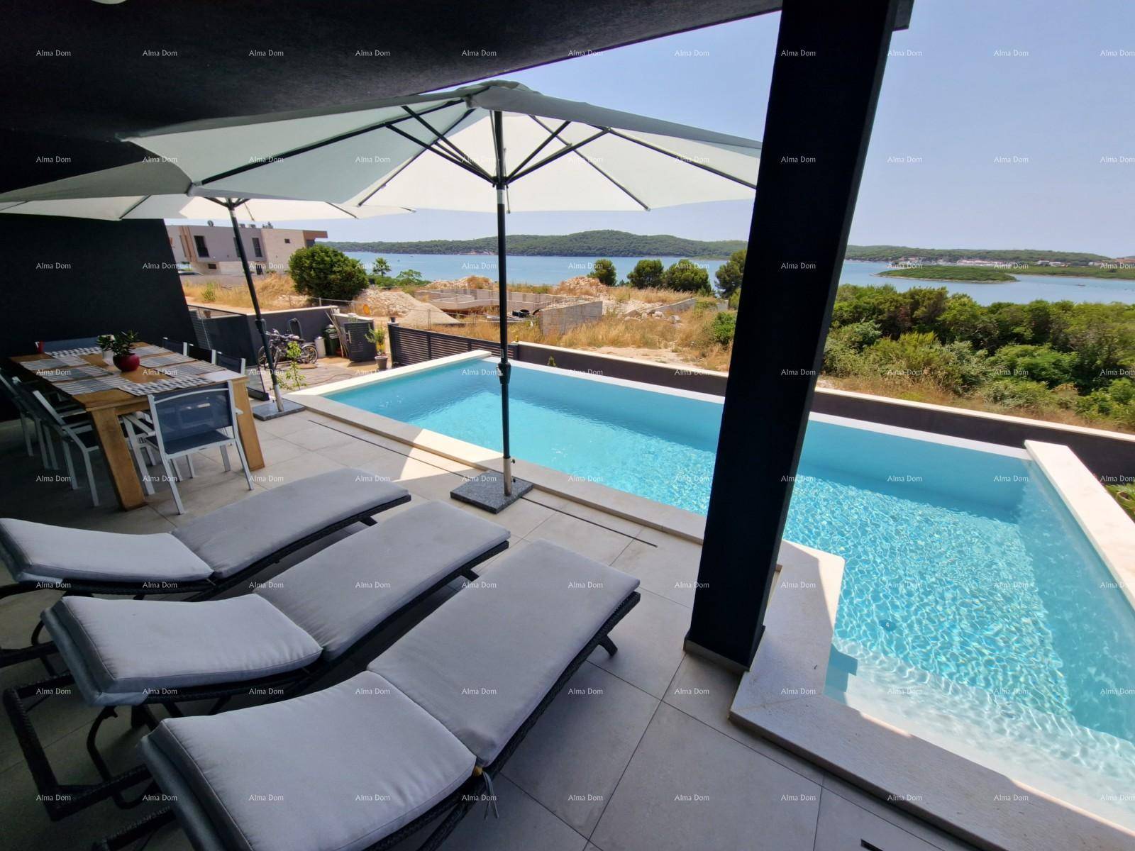 Entspannungsbereich auf der Terrasse mit Sonnenliegen und Blick auf den Pool und das Meer.