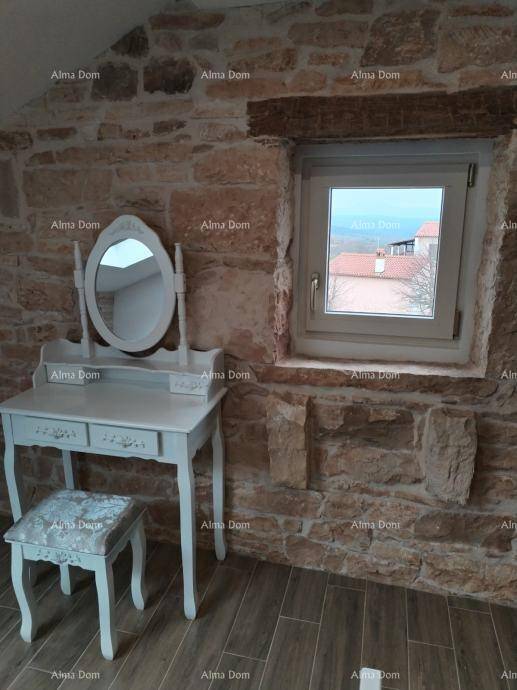 Charmante Schminkecke mit Fenster und Steinwand, bietet einen hellen und funktionalen Bereich im Schlafzimmer.