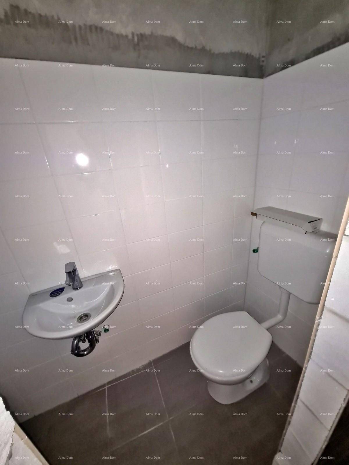 Kleines Badezimmer mit WC, Waschbecken und weißen Fliesen an den Wänden und auf dem Boden.