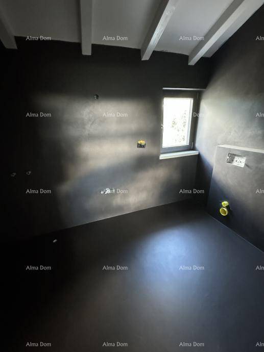 Unfertiges Badezimmer mit dunklen Wänden, Fenster und sichtbaren Installationen im Dachgeschoss.