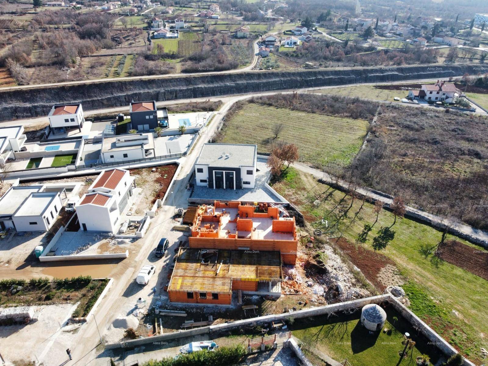 Überblick über eine Wohnsiedlung im Bau, mit Rohbauten und bereits fertiggestellten Gebäuden.