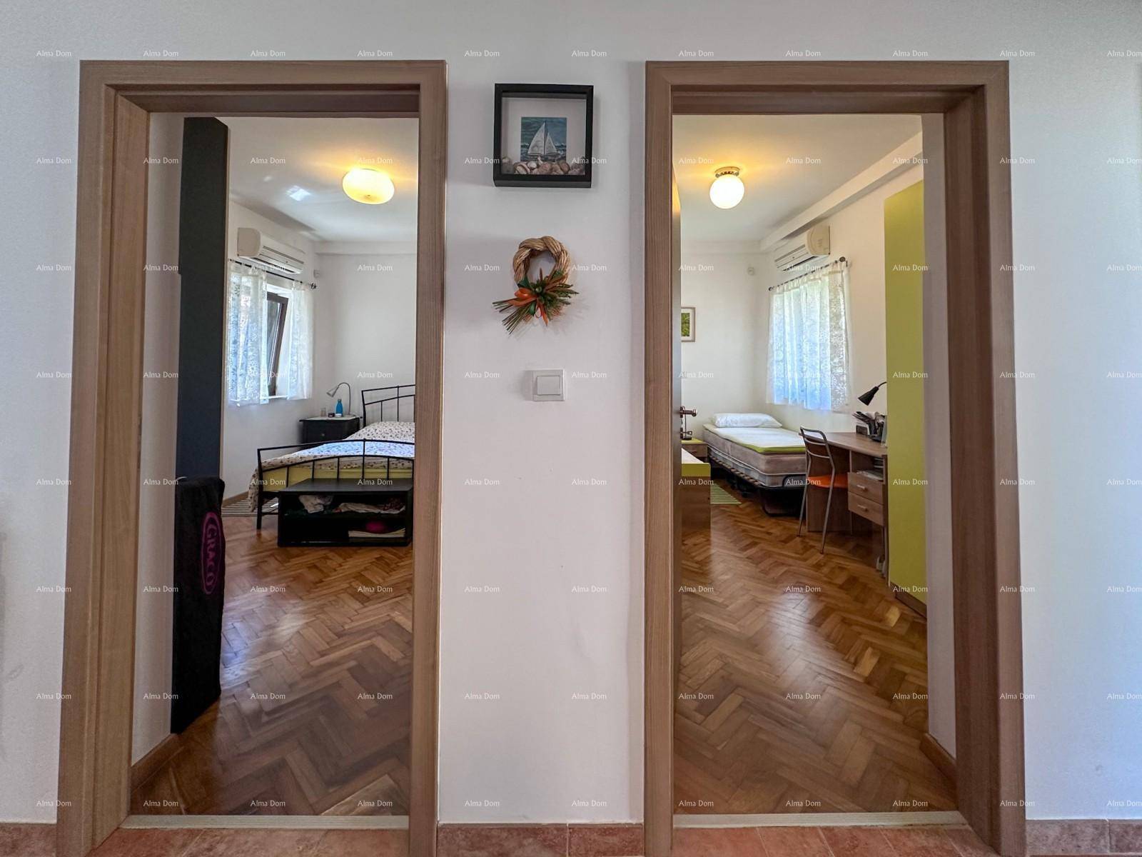 Flur mit Blick in zwei Schlafzimmer, beide mit Parkettboden und Fenstern.