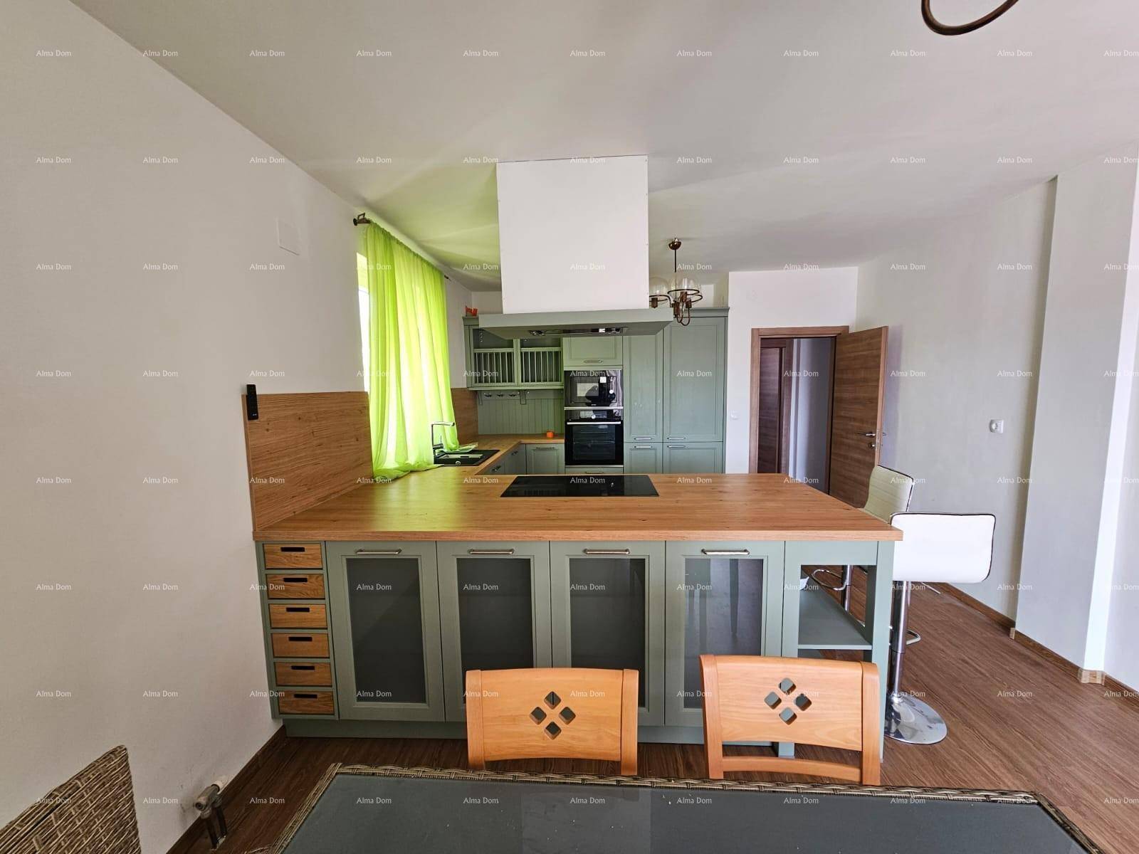 Moderne Küche mit grünen Schränken, Holztheke und integrierten Geräten.