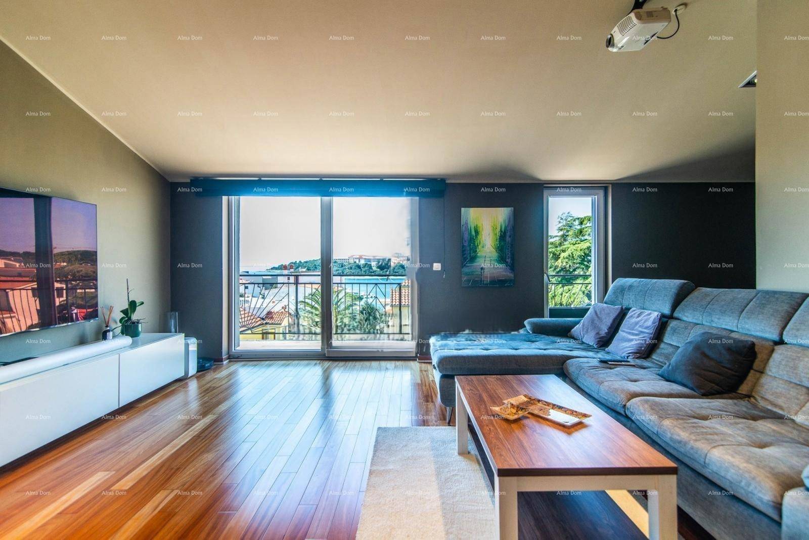 Gemütliches Wohnzimmer mit Holzboden, großem Sofa und Zugang zum Balkon mit Meerblick.