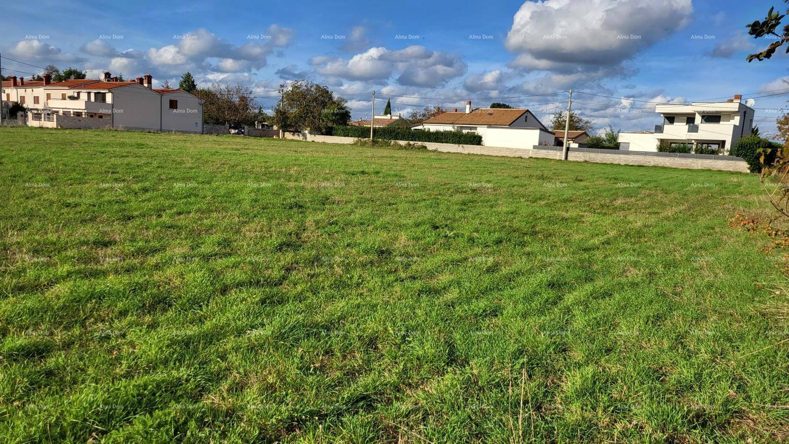 Großes grünes Grundstück mit Blick auf mehrere Wohnhäuser und eine ländliche Umgebung.