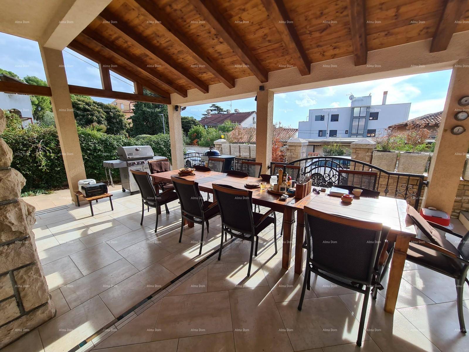 Große überdachte Terrasse mit Esstisch und Grill, ideal für gesellige Runden im Freien.