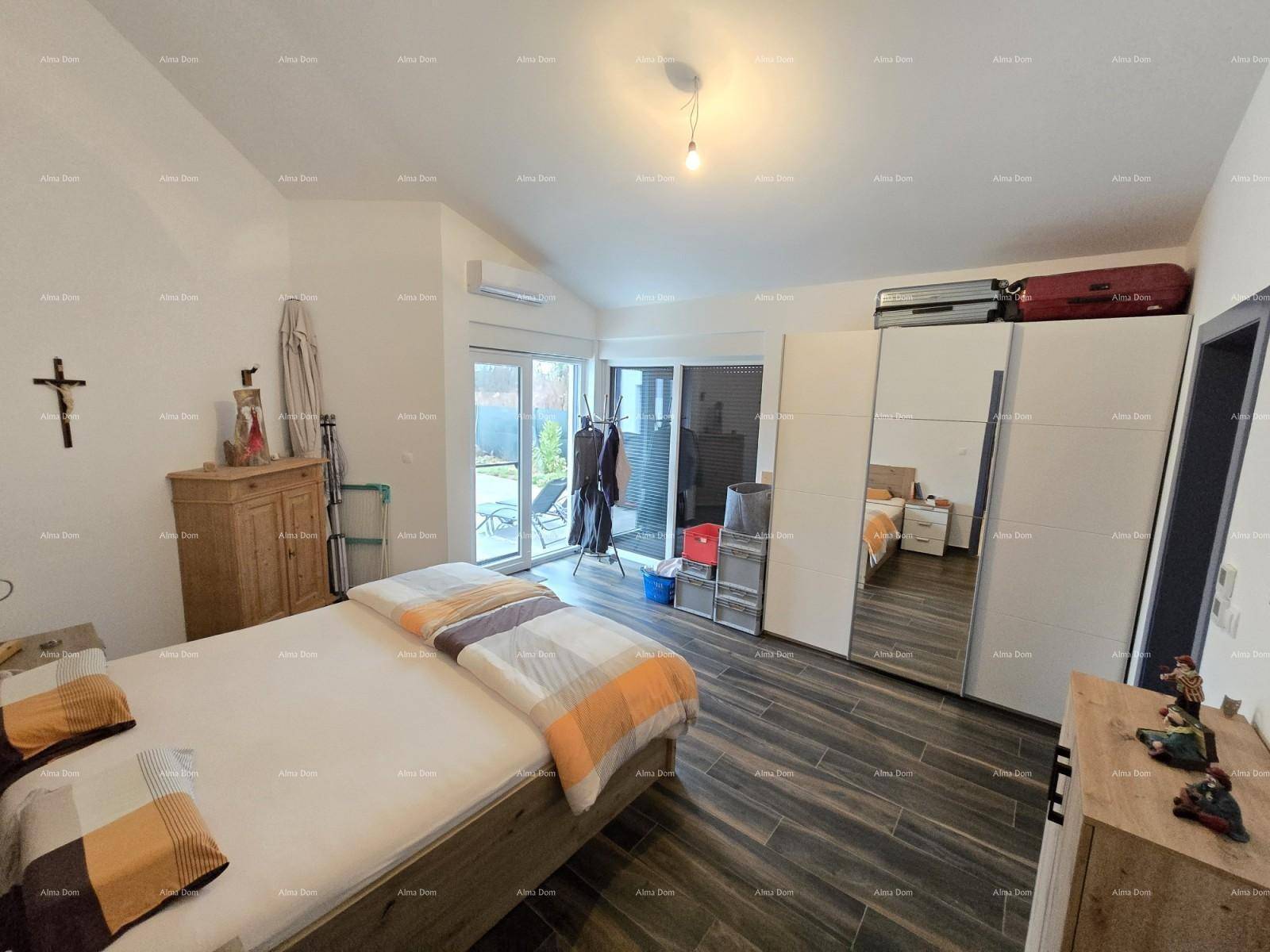 Schlafzimmer mit Doppelbett, großem Kleiderschrank und Zugang zur Terrasse.