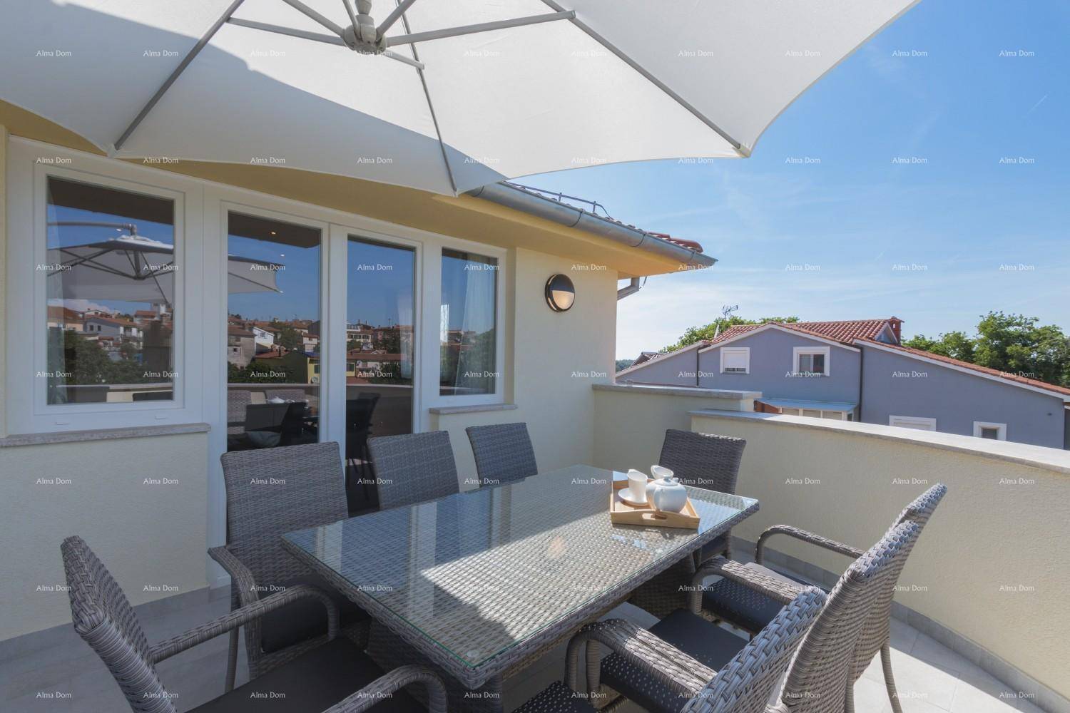 Detailansicht des Esstisches auf der Terrasse mit Blick auf die Dächer der Stadt und den blauen Himmel.