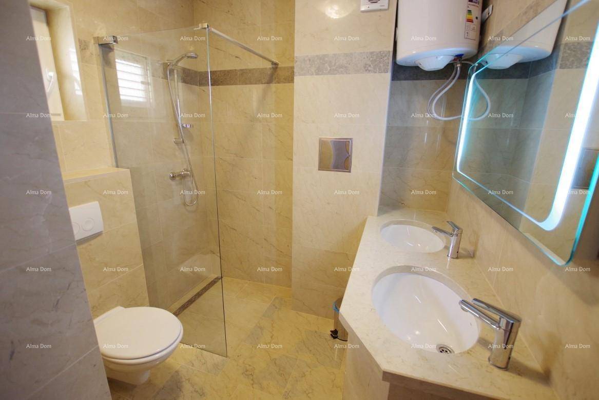 Modernes Badezimmer mit doppelten Waschbecken, begehbarer Dusche und Wand-WC.