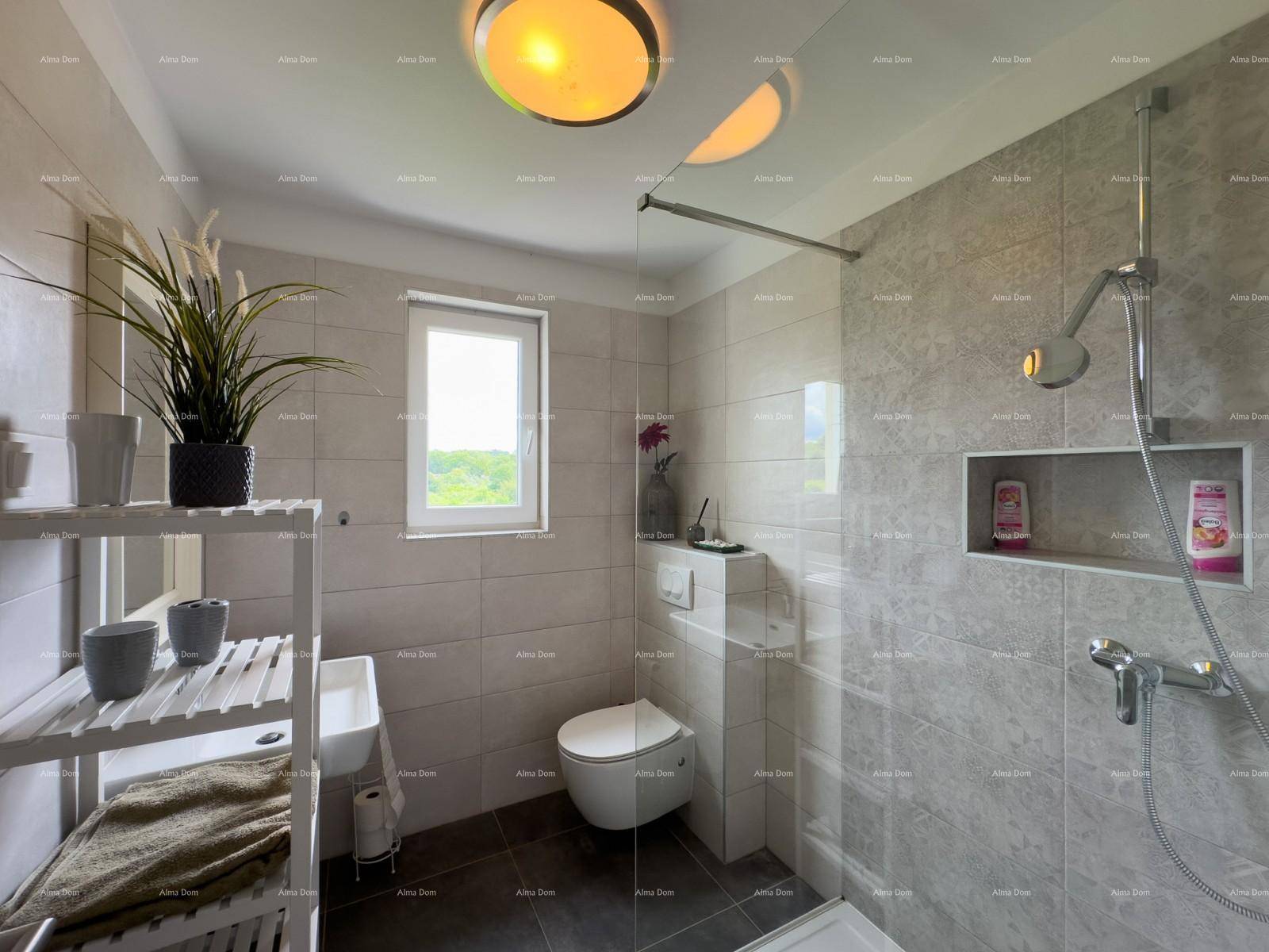 Modernes Badezimmer mit Duschkabine, wandhängendem WC und Fenster mit Blick ins Grüne.