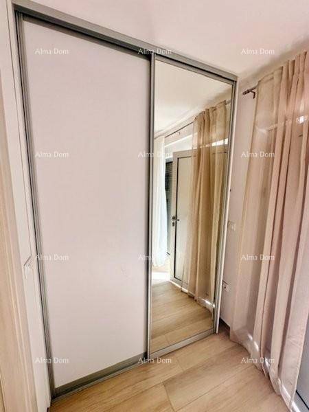 Einbauschrank mit Spiegeltür und Vorhängen in einem hellen Raum.