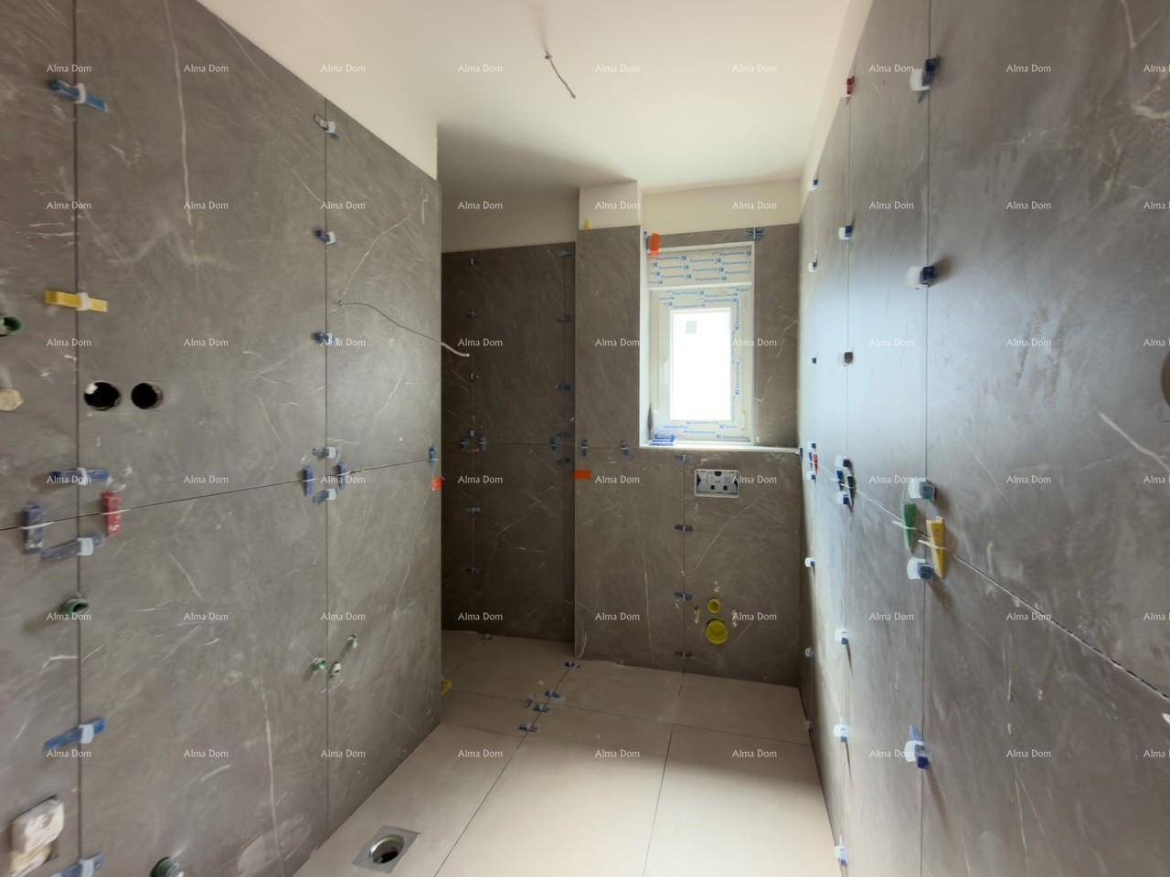 Badezimmer im Rohbau mit modernen grauen Fliesen an Wänden und Boden, bereit für die Installation.