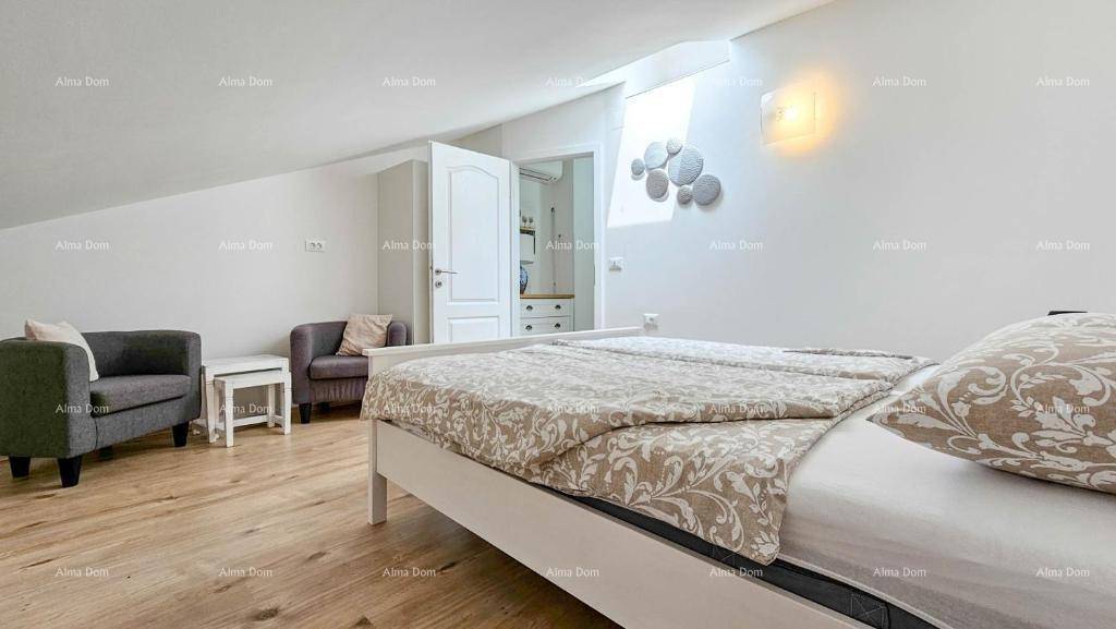 Gemütliches Schlafzimmer im Dachgeschoss mit Holzboden und schrägen Wänden.