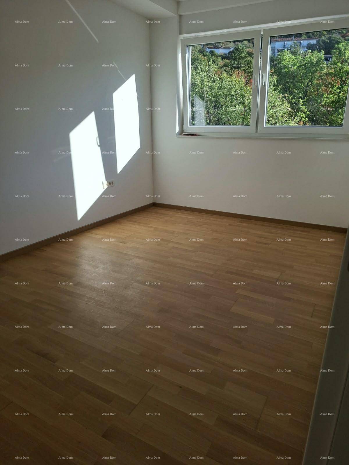 Helles Schlafzimmer mit Parkettboden und Fenster, das viel Tageslicht und einen grünen Ausblick bietet.