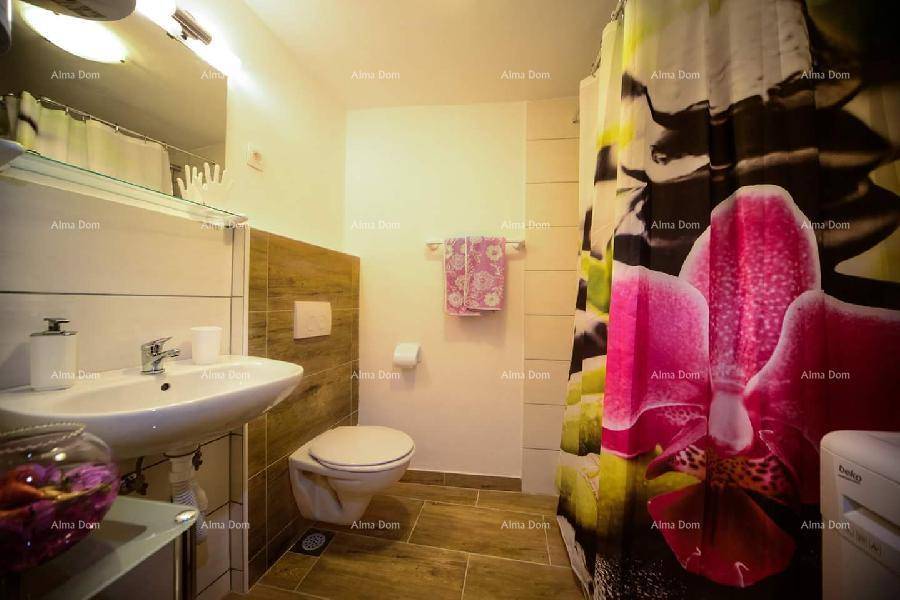Modernes Badezimmer mit Duschbereich, WC, Waschbecken und Holzoptik-Fliesen.